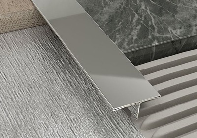 Flat bar transition trim installed between laminate flooring surfaces